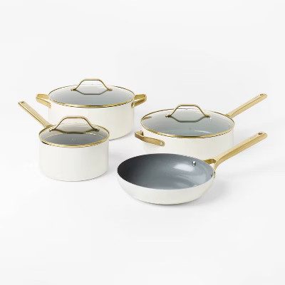 Cream ceramic coated cookware set with champagne gold handles from Target, a Caraway cookware alternative