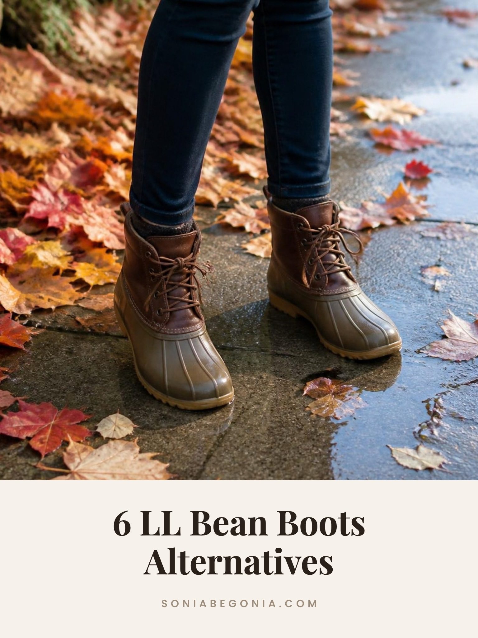 LL Bean boots alternatives: brown duck boots with dark jeans on a wet autumn sidewalk covered in leaves