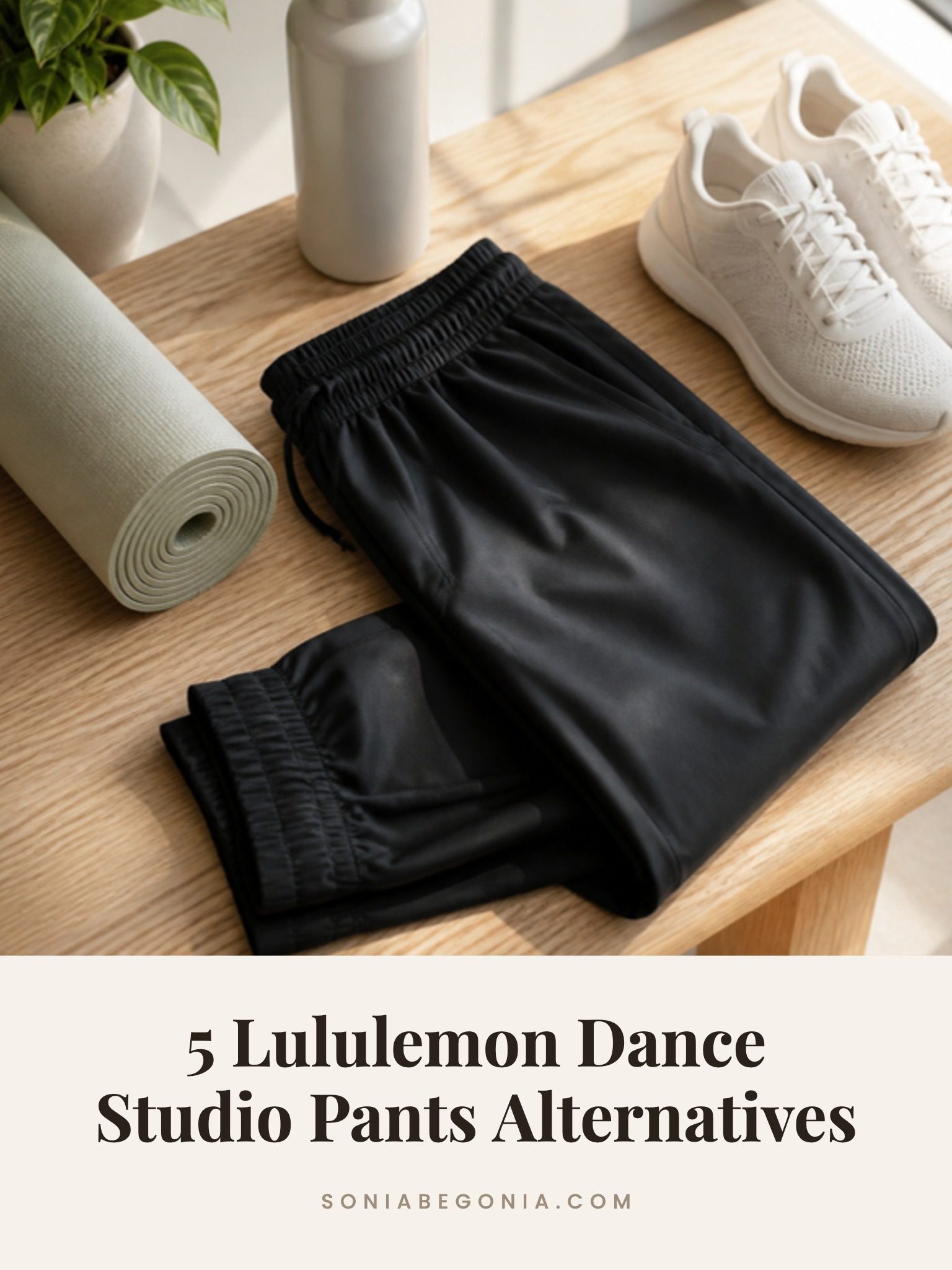 Lululemon Dance Studio pants alternatives: black lightweight joggers folded on an oak bench with white sneakers and a yoga mat