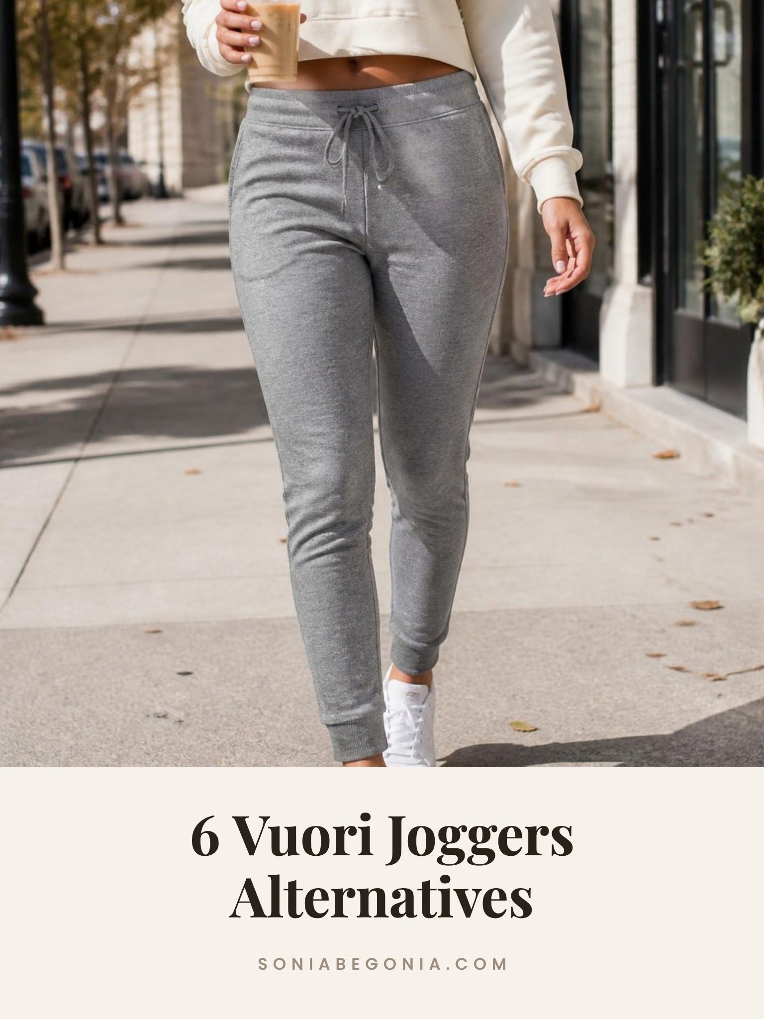 Vuori joggers alternatives: heather gray tapered joggers with white sneakers and a cream sweatshirt on a city sidewalk